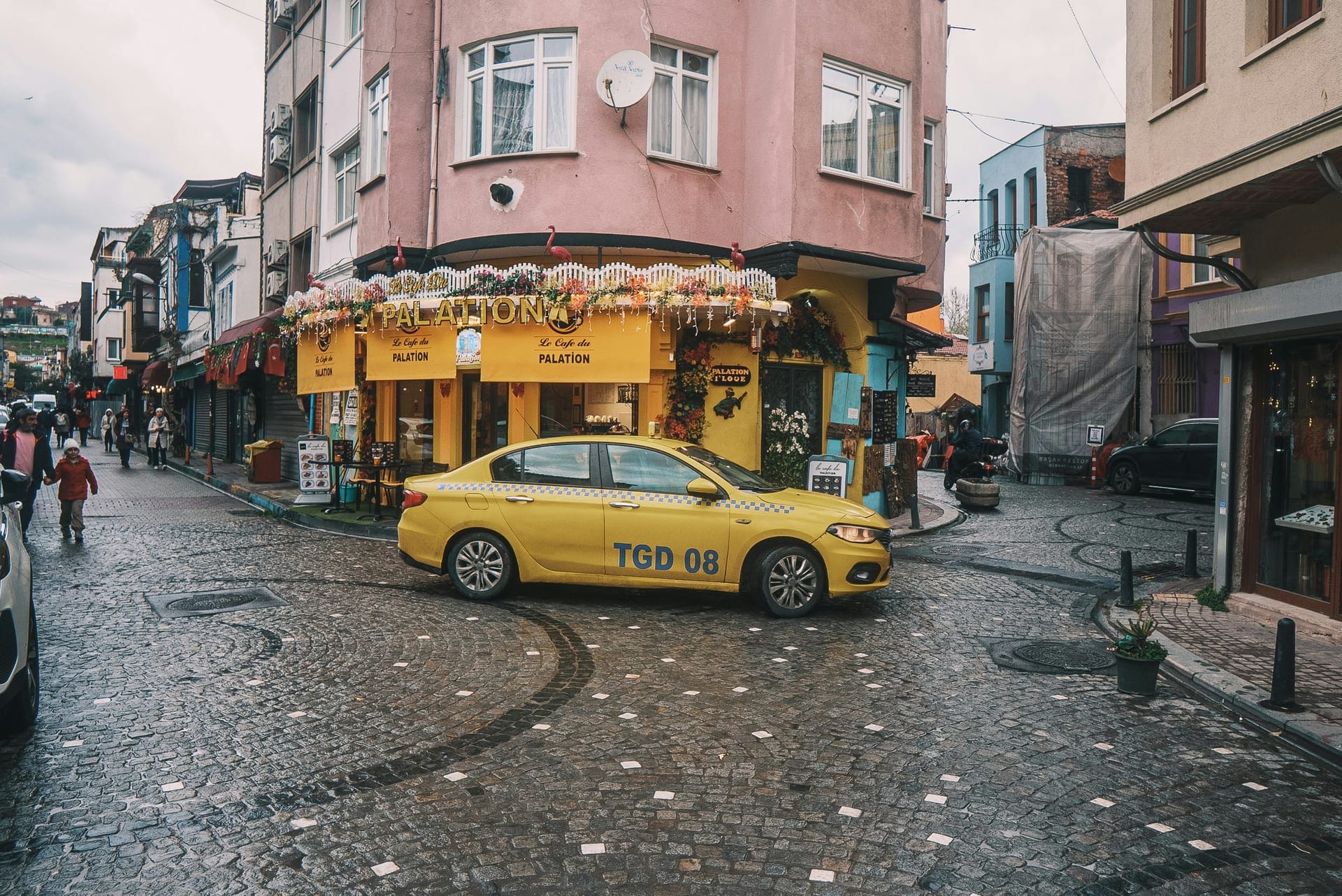 Yellow taxi on a cobblestone street in Türkiye