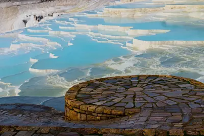 Breathtaking view of Pamukkale's natural travertine terraces filled with turquoise water in Turkey.