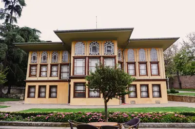 Front view of the historical Aynalıkavak Pavilion in Istanbul surrounded by greenery.