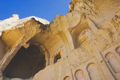 Explore the historic rock-cut architecture in Göreme, Cappadocia with intricate frescoes.